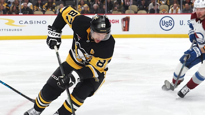 Mar 24, 2026; Pittsburgh, Pennsylvania, USA;  Pittsburgh Penguins center Sidney Crosby (87) moves the puck against Colorado Avalanche center Brock Nelson (11) and right wing Valeri Nichushkin (13) during the third period t PPG Paints Arena. Mandatory Credit: Charles LeClaire-Imagn Images