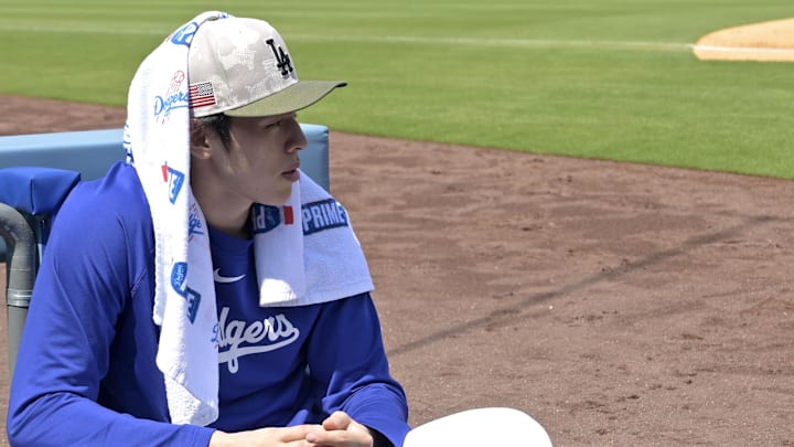 Los Angeles Dodgers starting pitcher Roki Sasaki (11) looks on from the dugout during the game against the Los Angeles Angels at Dodger Stadium on May 18.