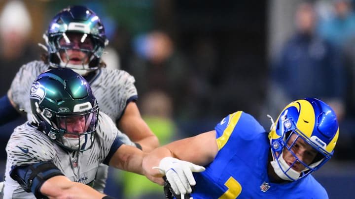 Seattle Seahawks safety Ty Okada tackles Los Angeles Rams tight end Terrance Ferguson.