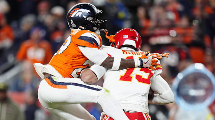 Nov 16, 2025; Denver, Colorado, USA; Denver Broncos cornerback Ja'Quan McMillian (29) sacks Kansas City Chiefs quarterback Patrick Mahomes (15) in the fourth quarter at Empower Field at Mile High. Mandatory Credit: Ron Chenoy-Imagn Images