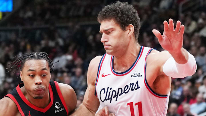 Toronto Raptors forward Scottie Barnes drives to the basket as LA Clippers center Brook Lopez tries to defend.
