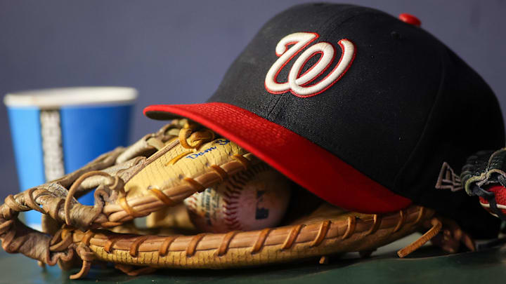 A detailed view of a Washington Nationals hat and glove A detailed view of a Washington Nationals hat and glove