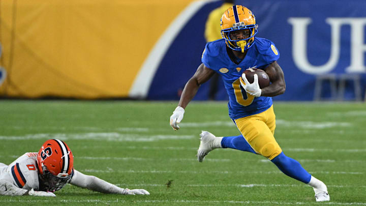 Oct 24, 2024; Pittsburgh, Pennsylvania, USA; Pittsburgh Panthers running back Desmond Reid (0) eludes Syracuse Orange defensive back Duce Chestnut (0) during the first quarter  at Acrisure Stadium. Mandatory Credit: Barry Reeger-Imagn Images