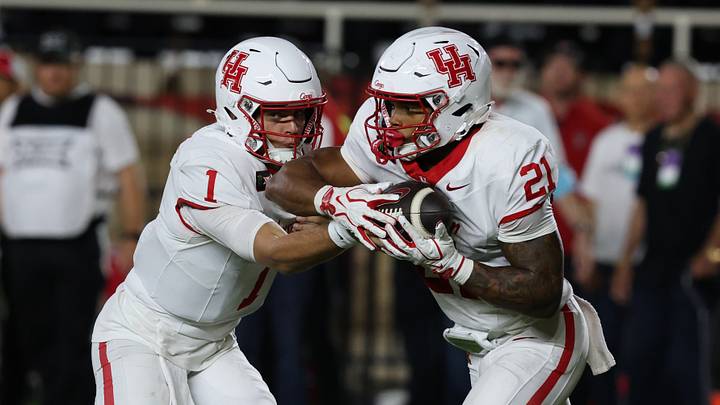 Sep 18, 2026; Lubbock, Texas, USA; Houston Cougars quarterback Conner Weigman (1) gives the ball to running back Makhi Huges (21) in the second half against the Texas Tech Red Raiders at Galaxy Stadium. Mandatory Credit: Michael C. Johnson-Imagn Images Sep 18, 2026; Lubbock, Texas, USA; Houston Cougars quarterback Conner Weigman (1) gives the ball to running back Makhi Huges (21) in the second half against the Texas Tech Red Raiders at Galaxy Stadium. Mandatory Credit: Michael C. Johnson-Imagn Images