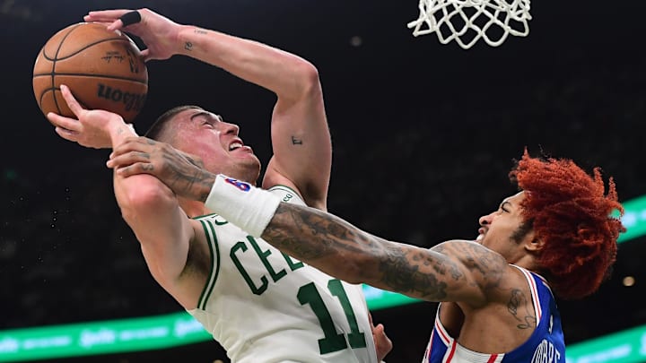 Apr 19, 2026; Boston, Massachusetts, USA; Boston Celtics guard Payton Pritchard (11) gets fouled by Philadelphia 76ers guard Kelly Oubre Jr. (9) in the second half during game one of the first round of the 2026 NBA Playoffs at TD Garden. Mandatory Credit: Bob DeChiara-Imagn Images