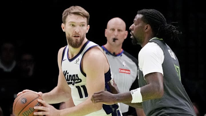 Nov 14, 2025; Minneapolis, Minnesota, USA; Sacramento Kings center Domantas Sabonis (11) works around Minnesota Timberwolves center Naz Reid (11) in the second quarter at Target Center.