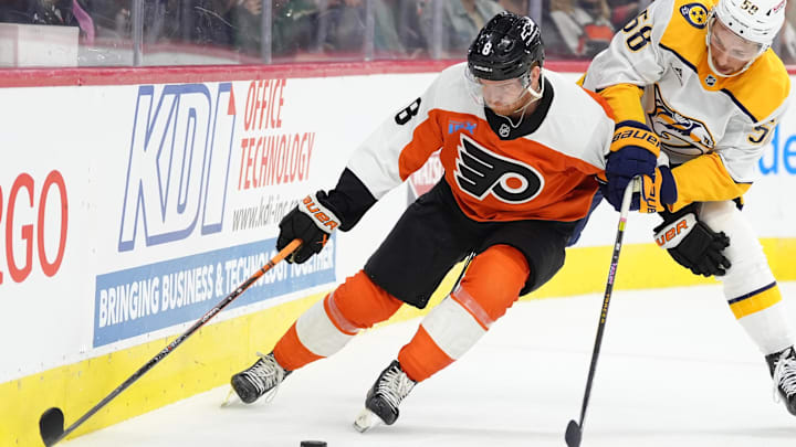 Mar 31, 2025; Philadelphia, Pennsylvania, USA; Philadelphia Flyers defenseman Cam York (8) and Nashville Predators left wing Michael Bunting (58) battle for the puck in the first period at Wells Fargo Center. Mandatory Credit: Kyle Ross-Imagn Images
