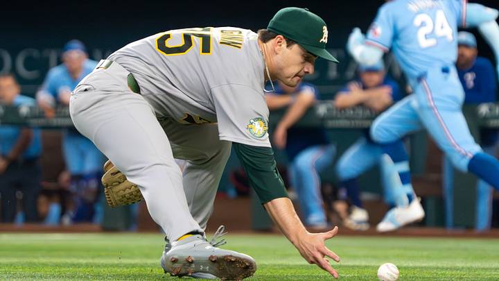 Apr 26, 2026; Arlington, Texas, USA; Athletics pitcher J.T. Ginn (35) attempts to field a ground ball by Texas Rangers left fielder Brandon Nimmo (24), who reached on an infield single during the first inning at Globe Life Field. Mandatory Credit: Raymond Carlin III-Imagn Images Apr 26, 2026; Arlington, Texas, USA; Athletics pitcher J.T. Ginn (35) attempts to field a ground ball by Texas Rangers left fielder Brandon Nimmo (24), who reached on an infield single during the first inning at Globe Life Field. Mandatory Credit: Raymond Carlin III-Imagn Images