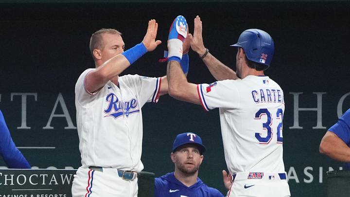 Texas Rangers center fielder Evan Carter is greeted by third baseman Josh Jung at the dugout steps after scoring. Texas Rangers center fielder Evan Carter is greeted by third baseman Josh Jung at the dugout steps after scoring.