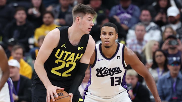 Oct 29, 2024; Salt Lake City, Utah, USA; Utah Jazz forward Kyle Filipowski (22) holds the ball while Sacramento Kings forward Keegan Murray (13) defends during the second quarter at Delta Center. Mandatory Credit: Rob Gray-Imagn Images