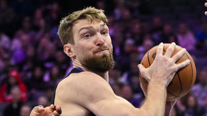 Feb 4, 2026; Sacramento, California, USA; Sacramento Kings forward/center Domantas Sabonis (11) rebounds against Memphis Grizzlies guard Cedric Coward (23) during the third quarter at Golden 1 Center. Mandatory Credit: Ed Szczepanski-Imagn Images