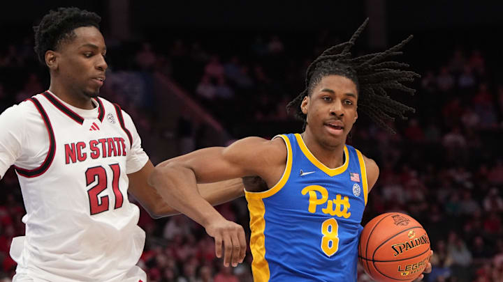 Mar 11, 2026; Charlotte, NC, USA; Pittsburgh Panthers guard Omari Witherspoon (8) with the ball as NC State Wolfpack guard Terrance Arceneaux (21) defends in the first half at Spectrum Center. Mandatory Credit: Bob Donnan-Imagn Images