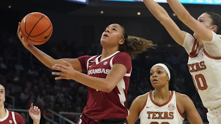 Arkansas Razorbacks guard Phoenix Stotijn (1) drives to the basket past Texas Longhorns guard Shay Holle (10) and forward Aaliyah Moore (23) during the second half at Moody Center.