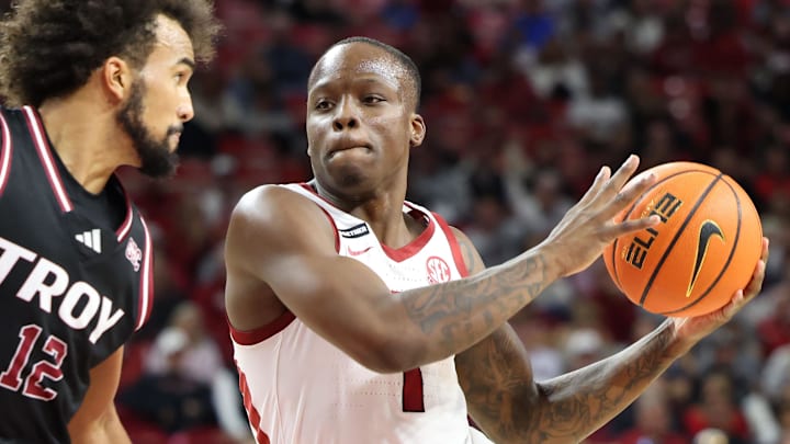Arkansas Razorbacks guard Nelly Davis (1) drives against Troy Trojans guard Tayton Conway (12) during the second half at Bud Walton Arena last Wednesday. Arkansas won 65-49. The Hogs return to the court Friday against Little Rock.