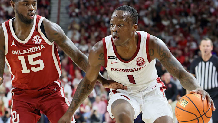 Arkansas Razorbacks guard Johnell Davis (1) drives against Oklahoma Sooners guard Duke Miles (15) during the second half at Bud Walton Arena. Oklahoma won 65-62.