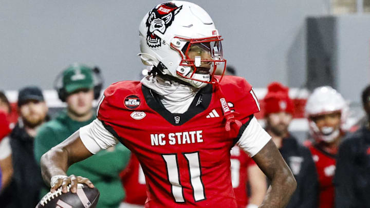 Nov 29, 2025; Raleigh, North Carolina, USA;  NC State Wolfpack quarterback CJ Bailey (11) prepares to throw the football during the first half of the game against North Carolina Tar Heels at Carter-Finley Stadium.  Mandatory Credit: Jaylynn Nash-Imagn Images