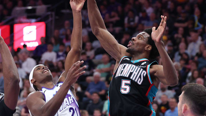 Apr 10, 2026; Salt Lake City, Utah, USA; Utah Jazz guard Bez Mbeng (21) goes to the basket against Memphis Grizzlies guard Jahmai Mashack (21) and forward Toby Okani (5) during the second half at Delta Center. Mandatory Credit: Rob Gray-Imagn Images