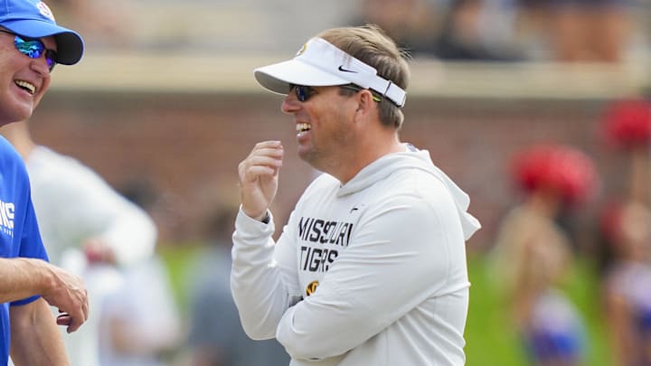Sep 6, 2025; Columbia, Missouri, USA; Kansas Jayhawks head coach Lance Leipold talks with Missouri Tigers head coach Eliah Drinkwitz prior to a game at Faurot Field at Memorial Stadium. Mandatory Credit: Jay Biggerstaff-Imagn Images