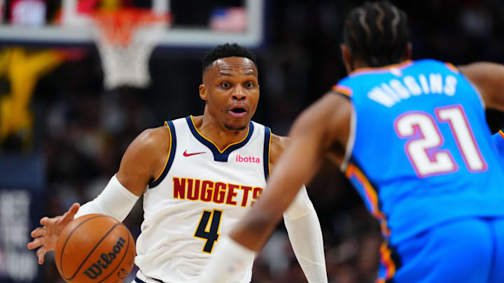 Oct 24, 2024; Denver, Colorado, USA; Denver Nuggets guard Russell Westbrook (4) drives at Oklahoma City Thunder guard Aaron Wiggins (21) in the second half at Ball Arena. Mandatory Credit: Ron Chenoy-Imagn Images