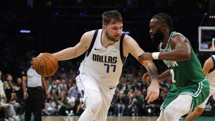 Jun 17, 2024; Boston, Massachusetts, USA; Dallas Mavericks guard Luka Doncic (77) dribbles the ball against Boston Celtics guard Jaylen Brown (7) during the second quarter in game five of the 2024 NBA Finals at TD Garden. Mandatory Credit: Peter Casey-USA TODAY Sports