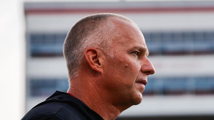 Aug 28, 2025; Raleigh, North Carolina, USA; North Carolina State Wolfpack head coach Dave Doeren looks on during the warmups prior to the game against East Carolina Pirates at Carter-Finley Stadium. Mandatory Credit: Jaylynn Nash-Imagn Images