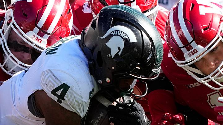 Oct 3, 2026; Madison, Wisconsin, USA; Michigan State Spartans running back Jaziun Patterson (4) is tackled while carrying the football during the fourth quarter against the Wisconsin Badgers at Camp Randall Stadium. Mandatory Credit: Jeff Hanisch-Imagn Images Oct 3, 2026; Madison, Wisconsin, USA; Michigan State Spartans running back Jaziun Patterson (4) is tackled while carrying the football during the fourth quarter against the Wisconsin Badgers at Camp Randall Stadium. Mandatory Credit: Jeff Hanisch-Imagn Images