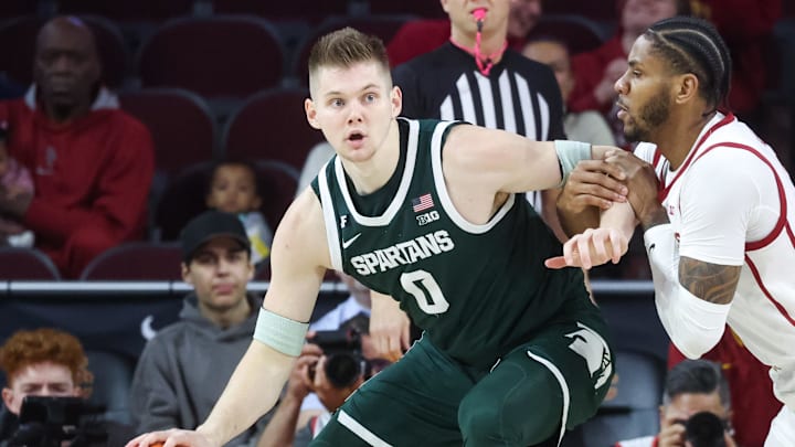 Feb 1, 2025; Los Angeles, California, USA;  Michigan State Spartans forward Jaxon Kohler (0) sets the post against USC Trojans guard Chibuzo Agbo (7) during the first half at Galen Center. Mandatory Credit: William Navarro-Imagn Images