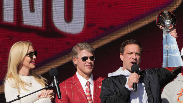 Feb 14, 2024; Kansas City, MO, USA; Kansas City Chiefs general manager Brett Veach speaks as owner Clark Hunt and wife Tavia Hunt and play-by-play announcer Mitch Holthus listen during the celebration of the Chiefs winning Super Bowl LVIII. Mandatory Credit: Kirby Lee-Imagn Images
