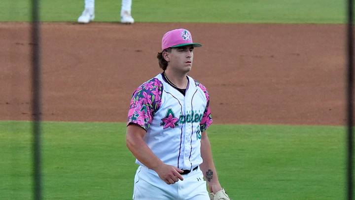 Apr 18, 2025; North Augusta, South Carolina, USA; Augusta GreenJackets Ethan Bagwell (18) is seen between the nets during the Augusta GreenJackets and Myrtle Beach baseball game at SRP Park. The Augusta GreenJackets unveiled their new Augusta Azalea uniforms. Mandatory Credit: Katie Goodale - Augusta Chronicle/USA TODAY NETWORK
