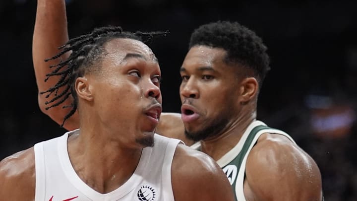 Toronto Raptors guard Scottie Barnes controls the ball against Milwaukee Bucks forward Giannis Antetokounmpo.