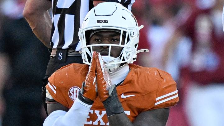 Texas Longhorns defensive end Colin Simmons (1) kneels on the field during the game between the Texas Longhorns and the Oklahoma Sooners at the Cotton Bowl. 