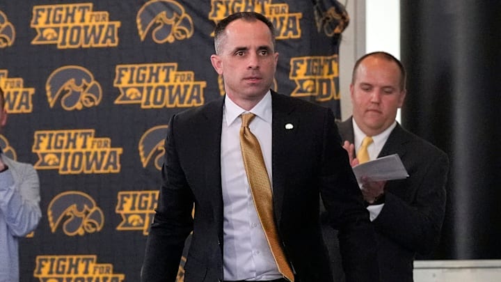 Ben McCollum, Iowa's new head men's basketball coach, walks to the podium during his introductory press conference Tuesday, March 25, 2025 at Carver-Hawkeye Arena in Iowa City, Iowa.