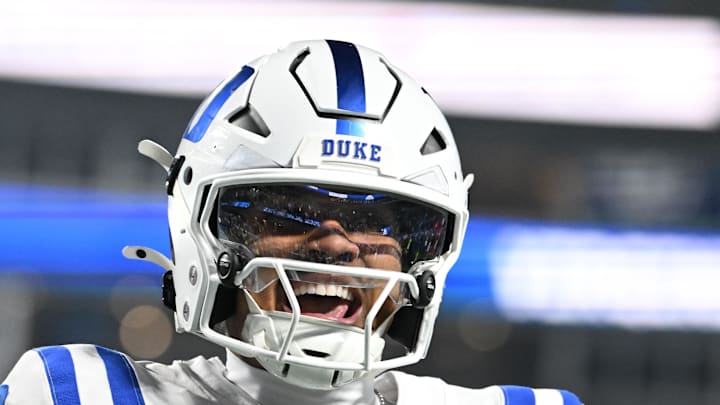 Dec 6, 2025; Charlotte, NC, USA; Duke Blue Devils quarterback Darian Mensah (10) celebrates after the Blue Devils score a touchdown in overtime during the  ACC Championship game at Bank of America Stadium. Mandatory Credit: Bob Donnan-Imagn Images