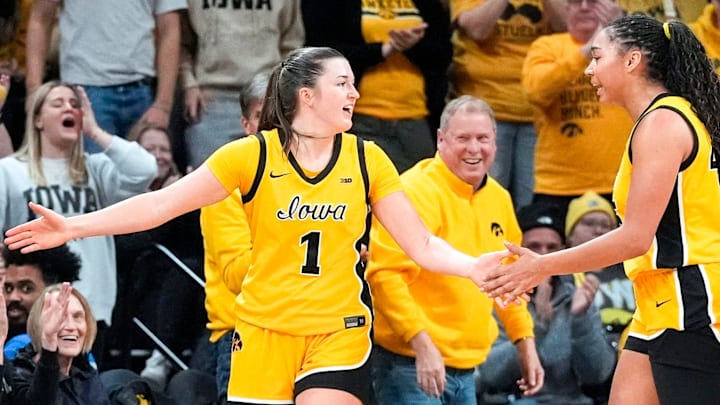 Iowa guard Taylor Stremlow (1) gets high-fives from Iowa forward Hannah Stuelke (45) and fans after forcing a Nebraska turnover Jan. 1, 2026 at Carver-Hawkeye Arena in Iowa City, Iowa. Iowa guard Taylor Stremlow (1) gets high-fives from Iowa forward Hannah Stuelke (45) and fans after forcing a Nebraska turnover Jan. 1, 2026 at Carver-Hawkeye Arena in Iowa City, Iowa.