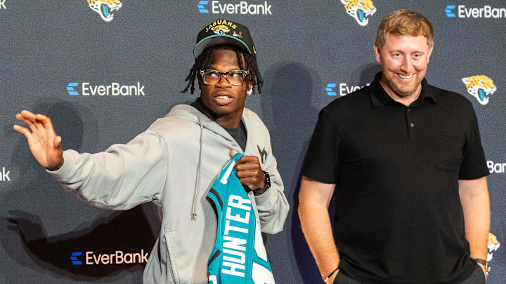 The Jacksonville Jaguars’ first-round pick, Colorado Buffaloes wide receiver and defensive back Travis Hunter, center, throws up the Heisman pose to Tony Boselli, Executive Vice President of Football Operations, left, as Head Coach Liam Coen, right, laughs after a press conference Friday, March 25, 2025 at Miller Electric Center in Jacksonville, Fla. The team traded up from fifth to second after making a deal with the Cleveland Browns on Thursday night. The rookie was introduced with general
