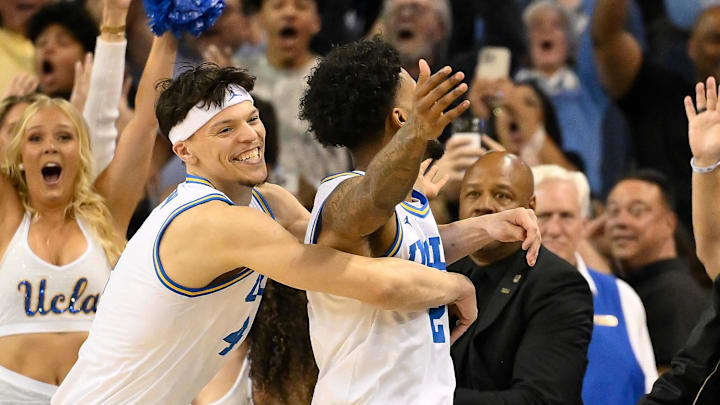 Feb 21, 2026; Los Angeles, California, USA; UCLA guard Donovan Dent (2) celebrates scoring the winning basket in overtime against the Illinois Fighting Illini at Pauley Pavilion presented by Wescom Financial. Mandatory Credit: Robert Hanashiro-Imagn Images