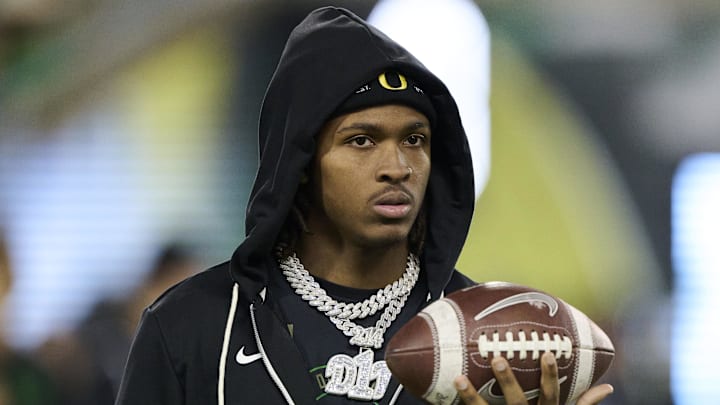 Nov 14, 2025; Eugene, Oregon, USA; Oregon Ducks wide receiver Dakorien Moore (1) watches teammates warm up before a game against the Minnesota Golden Gophers at Autzen Stadium. Mandatory Credit: Troy Wayrynen-Imagn Images