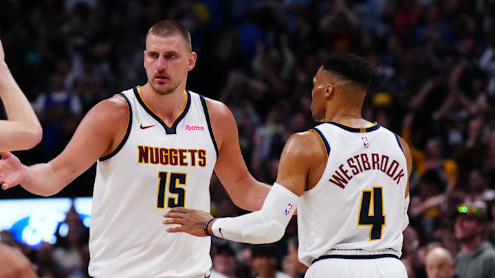 Apr 11, 2025; Denver, Colorado, USA; Denver Nuggets center Nikola Jokic (15) and guard Russell Westbrook (4) celebrate defeating the against the Memphis Grizzlies in the second half at Ball Arena.