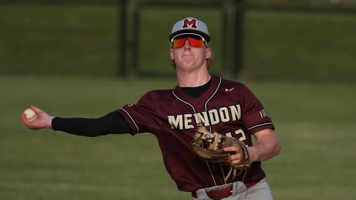 Mendon shortstop Colden Forney turns a double play over East's Dabdiel Ramos in the seventh inning.