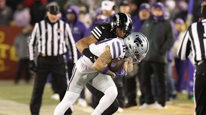 Nov 30, 2024; Ames, Iowa, USA;  Iowa State Cyclones defensive back Jamison Patton (2) tackles Kansas State Wildcats wide receiver Keagan Johnson (10) in the first quarter at at Jack Trice Stadium. Mandatory Credit: Reese Strickland-Imagn Images
