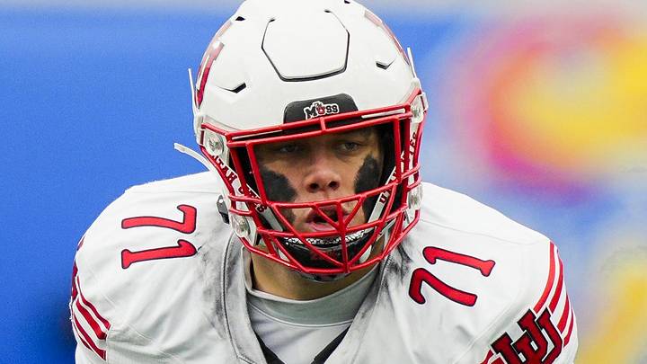 Nov 28, 2025; Lawrence, Kansas, USA; Utah Utes offensive lineman Caleb Lomu (71) gets ready before the snap during the second half against the Kansas Jayhawks at David Booth Kansas Memorial Stadium. Mandatory Credit: Jay Biggerstaff-Imagn Images