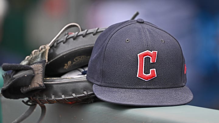 Jun 27, 2024; Kansas City, Missouri, USA; A general view a Cleveland Guardians hat and glove on the dugout railing  before a game against the Kansas City Royals at Kauffman Stadium. 