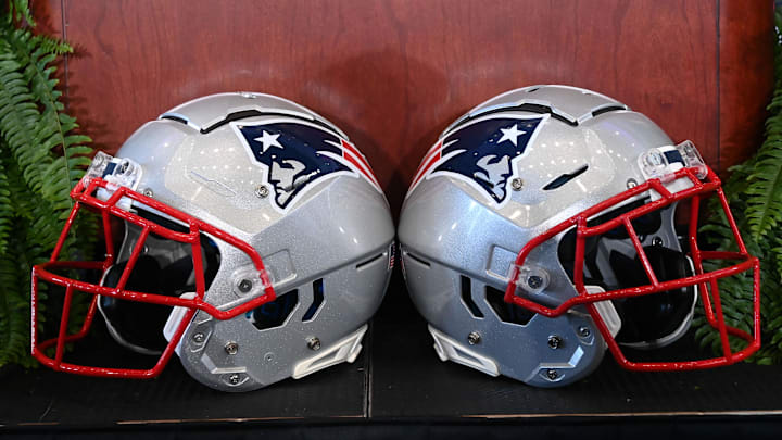 Jan 13, 2025; Foxborough, MA, USA; A pair of New England Patriots helmets sit in front of the podium before a press conference at Gillette Stadium. Mandatory Credit: Eric Canha-Imagn Images