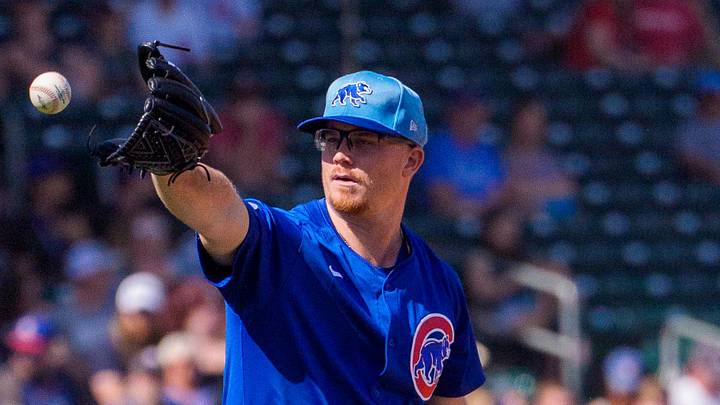 Feb 27, 2025; Mesa, Arizona, USA; Chicago Cubs pitcher Jordan Wicks (36) reaches out to grab ball while on the mound in the first inning during a spring training game against the Los Angeles Angels at Sloan Park. Mandatory Credit: Allan Henry-Imagn Images