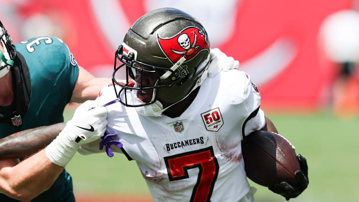 Sep 28, 2025; Tampa, Florida, USA; Tampa Bay Buccaneers running back Bucky Irving (7) attempts to stiff arm Philadelphia Eagles cornerback Cooper Dejean (33) during the first quarter at Raymond James Stadium. Mandatory Credit: Nathan Ray Seebeck-Imagn Images