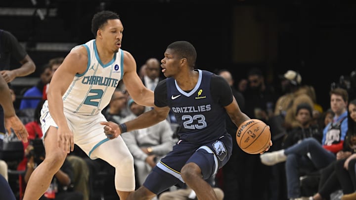 Jan 28, 2026; Memphis, Tennessee, USA; Memphis Grizzlies forward Cedric Coward (23) drives into defender Charlotte Hornets forward Grant Williams (2) in the third quarter at FedExForum. Mandatory Credit: Matthew Smith-Imagn Images