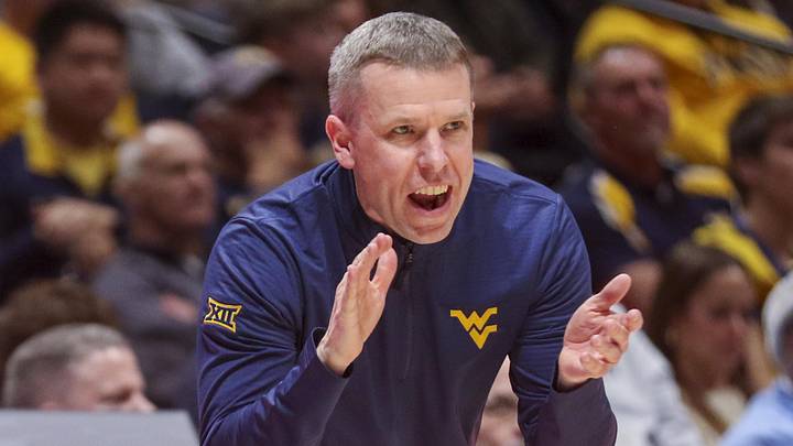 Dec 22, 2025; Morgantown, West Virginia, USA; West Virginia Mountaineers head coach Ross Hodge claps during the first half against the Mississippi Valley State Delta Devils at Hope Coliseum. Mandatory Credit: Ben Queen-Imagn Images