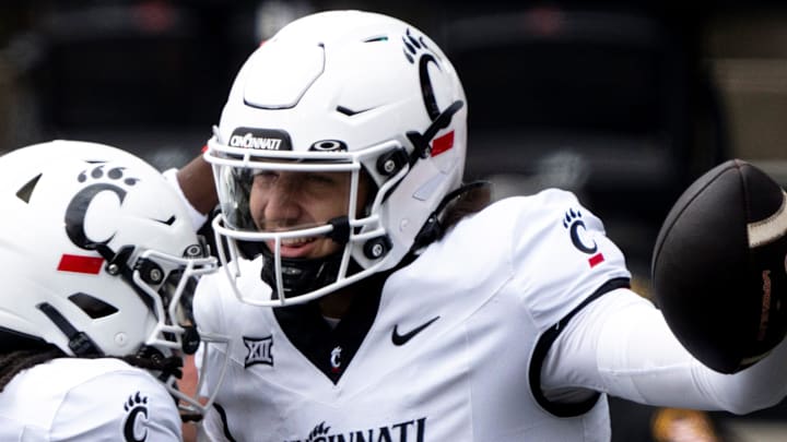 Cincinnati Bearcats quarterback Brendan Sorsby (2) reacts with Cincinnati Bearcats wide receiver Tyrin Smith (4) after scoring a touchdown in the first quarter of the College Football game between the Cincinnati Bearcats and the Towson Tigers at Nippert Stadium in Cincinnati on Saturday, Aug. 31, 2024. Cincinnati Bearcats quarterback Brendan Sorsby (2) reacts with Cincinnati Bearcats wide receiver Tyrin Smith (4) after scoring a touchdown in the first quarter of the College Football game between the Cincinnati Bearcats and the Towson Tigers at Nippert Stadium in Cincinnati on Saturday, Aug. 31, 2024.