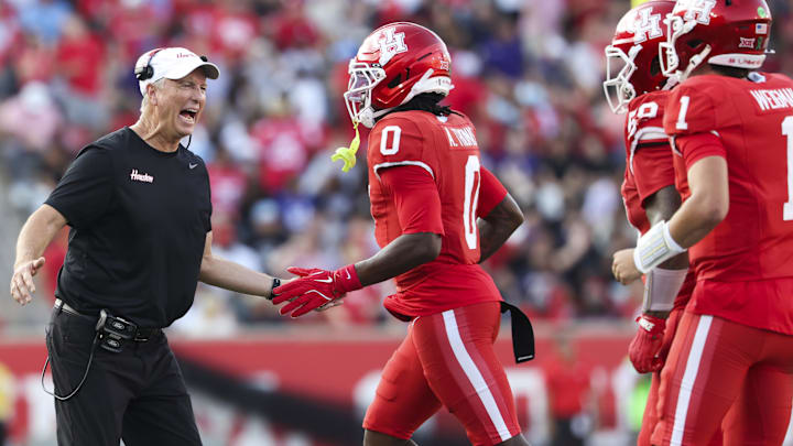 Houston Cougars head coach Willie Fritz celebrates with wide receiver Amare Thomas (0) after Thomas scores a touchdown during the second quarter against the TCU Horned Frogs at TDECU Stadium