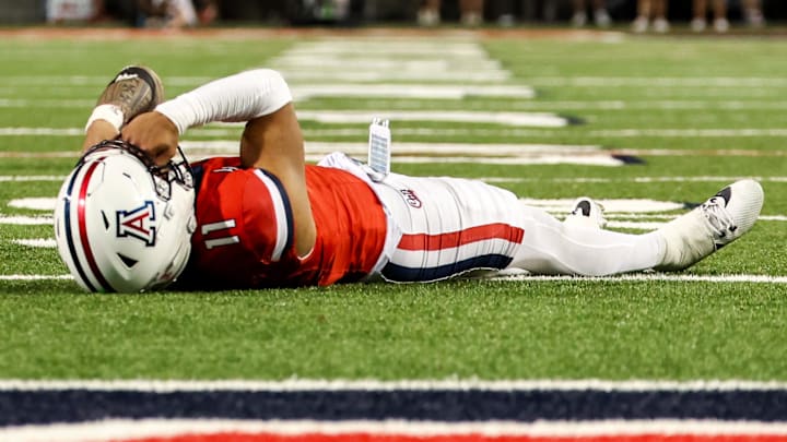 Oct 26, 2024; Tucson, Arizona, USA; Arizona Wildcats quarterback Noah Fifita (11) lays on ground in disappointment after he fails to catch the ball during the fourth quarter against the West Virginia Mountaineers at Arizona Stadium